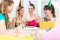 Best friends drinking champagne in front of a birthday cake Royalty Free Stock Photo