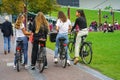 Group of female on bicycles in the city of Amsterdam. Healthy lifestyle - people riding bicycles in city park