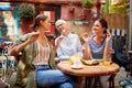 A group of female friends of different generations having a good time while they have a drink in the bar. Leisure, bar, friendship