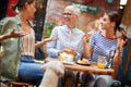 A group of female friends of different generations talking in the bar. Leisure, bar, friendship, outdoor