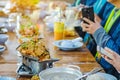 Group of female friends enjoy eating with acacia pennata omelette sour soup in fish shape hot pot in the restaurant. Selective Royalty Free Stock Photo