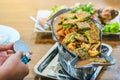 Group of female friends enjoy eating with acacia pennata omelette sour soup in fish shape hot pot in the restaurant. Royalty Free Stock Photo