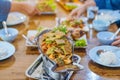 Group of female friends enjoy eating with acacia pennata omelette sour soup in fish shape hot pot in the restaurant. Selective Royalty Free Stock Photo