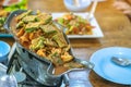 Group of female friends enjoy eating with acacia pennata omelette sour soup in fish shape hot pot in the restaurant. Selective Royalty Free Stock Photo