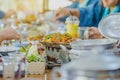 Group of female friends enjoy eating with acacia pennata omelette sour soup in fish shape hot pot in the restaurant. Selective Royalty Free Stock Photo