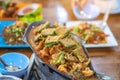 Group of female friends enjoy eating with acacia pennata omelette sour soup in fish shape hot pot in the restaurant. Selective Royalty Free Stock Photo