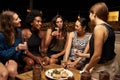 Group Of Female Friends Enjoying Night Out At Rooftop Bar Royalty Free Stock Photo