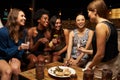 Group Of Female Friends Enjoying Night Out At Rooftop Bar Royalty Free Stock Photo