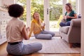 Group Of Female Friends Relaxing At Home Sitting On Sofa Chatting And Drinking Coffee Together Royalty Free Stock Photo