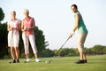 Group Of Female Golfers Teeing Off