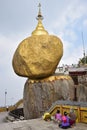 A group of female prilgrims sitting & kneeling in front of the stairs while praying at the Kyaiktiyo Pagoda, Myanmar