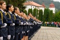 Group of female soldiers standing together in military uniforms and holding hats