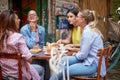 A group of female students is chatting while they have a drink in the bar. Leisure, bar, friendship, outdoor Royalty Free Stock Photo