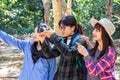Group of female tourists in the forest looked at their destination and were using cameras to capture memories.