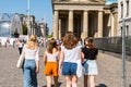 A group of female tourists walking to the Brandenburg Gate is an 18th-century neoclassical monument in Berlin