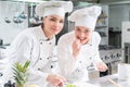 A group of female young chefs prepairing meal in luxury restaurant