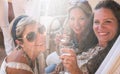 A group of females people in friendship enjoying a party on the terrace toasting with red wine. Beautiful women. Simplicity and Royalty Free Stock Photo