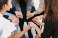group of females sitting in circle holding hands during support group meeting