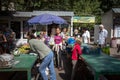 Group of females, women and girls, selling and buying food, essential goods like fruits and vegetables, on a stand on Lviv market