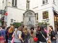 Several girls taking photos of Manneken Pis in Brussels in Belgium.