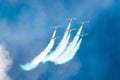 Group of fighter jet planes fly and leave behind a white smoke trail. Royalty Free Stock Photo