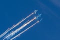 Group of fighters in the blue sky with a trace of black smoke and heat guns, bright flashes weapon shots Royalty Free Stock Photo