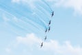 Group of fighters in the blue sky with a trace of black smoke and traces of white vapor vortex clouds Royalty Free Stock Photo