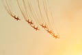 Group of fighters in the orange sky with a trace of black smoke and traces of white vapor vortex clouds Royalty Free Stock Photo