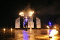 Group of fire jugglers performing at night show on stage, juggling with torches. Kyiv, Ukraine Royalty Free Stock Photo