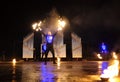 Group of fire jugglers performing at night show on stage, juggling with torches. Kyiv, Ukraine Royalty Free Stock Photo