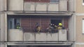 A group of firefighters rush to put out a fire in an apartment building