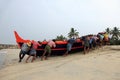 Fishermen work hard to bring the fishing boat to the shore