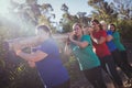 Group of fit women carrying a heavy wooden log during obstacle course training Royalty Free Stock Photo