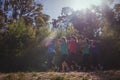 Group of fit women carrying a heavy wooden log during obstacle course training Royalty Free Stock Photo