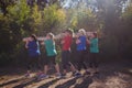 Group of fit women carrying a heavy wooden log during obstacle course training Royalty Free Stock Photo