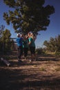 Group of fit women giving high five to each other in the boot camp Royalty Free Stock Photo