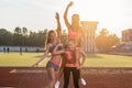 Group fit women giving piggyback ride Happy young friends enjoying a day in stadium. Royalty Free Stock Photo