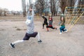 Group fitness workout classes outdoors. Socially Distant Outdoor Workout Classes in public parks. Three women and man