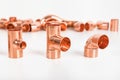 Group of fittings on a white background. Copper fittings for pipe connections. Technical basis for heating companies