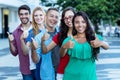 Group of five beautiful international young adults in line showing thumbs up Royalty Free Stock Photo