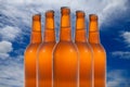 A group of five beer bottles in a diamond formation on sky background. Royalty Free Stock Photo