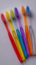 A group of five different colored toothbrushes sitting next to each other Royalty Free Stock Photo