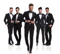 Group of five elegant men with leader buttoning suit Royalty Free Stock Photo