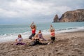 A group of five female friends are doing exercises on the beach. Beach holiday concept, healthy lifestyle Royalty Free Stock Photo