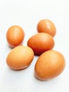 Group of Five Fresh Brown Chicken Eggs Scattered on Clean White Surface Royalty Free Stock Photo