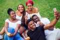 Group of five friends female and male taking selfie on camera smartphone and having fun outdoors lifestyle near lake Royalty Free Stock Photo