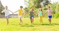 Group of five happy children jogging in a park Royalty Free Stock Photo