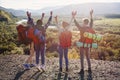 Group of five happy friends jumps at sunset time on background mountains Royalty Free Stock Photo