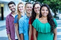 Group of five happy laughing international young adults in line Royalty Free Stock Photo