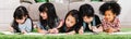 Group of five multi-ethnic young cute preschool kids, boy and girls happy study or drawing together at home or school Royalty Free Stock Photo